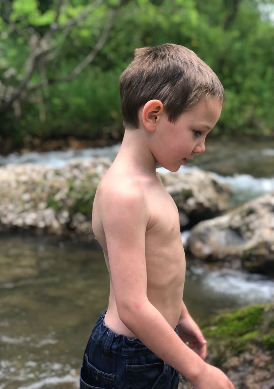 little boy in the creek