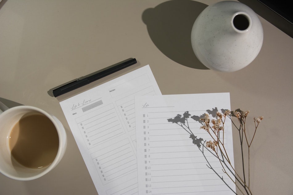 coffee, dried plants, and a paper list on a table