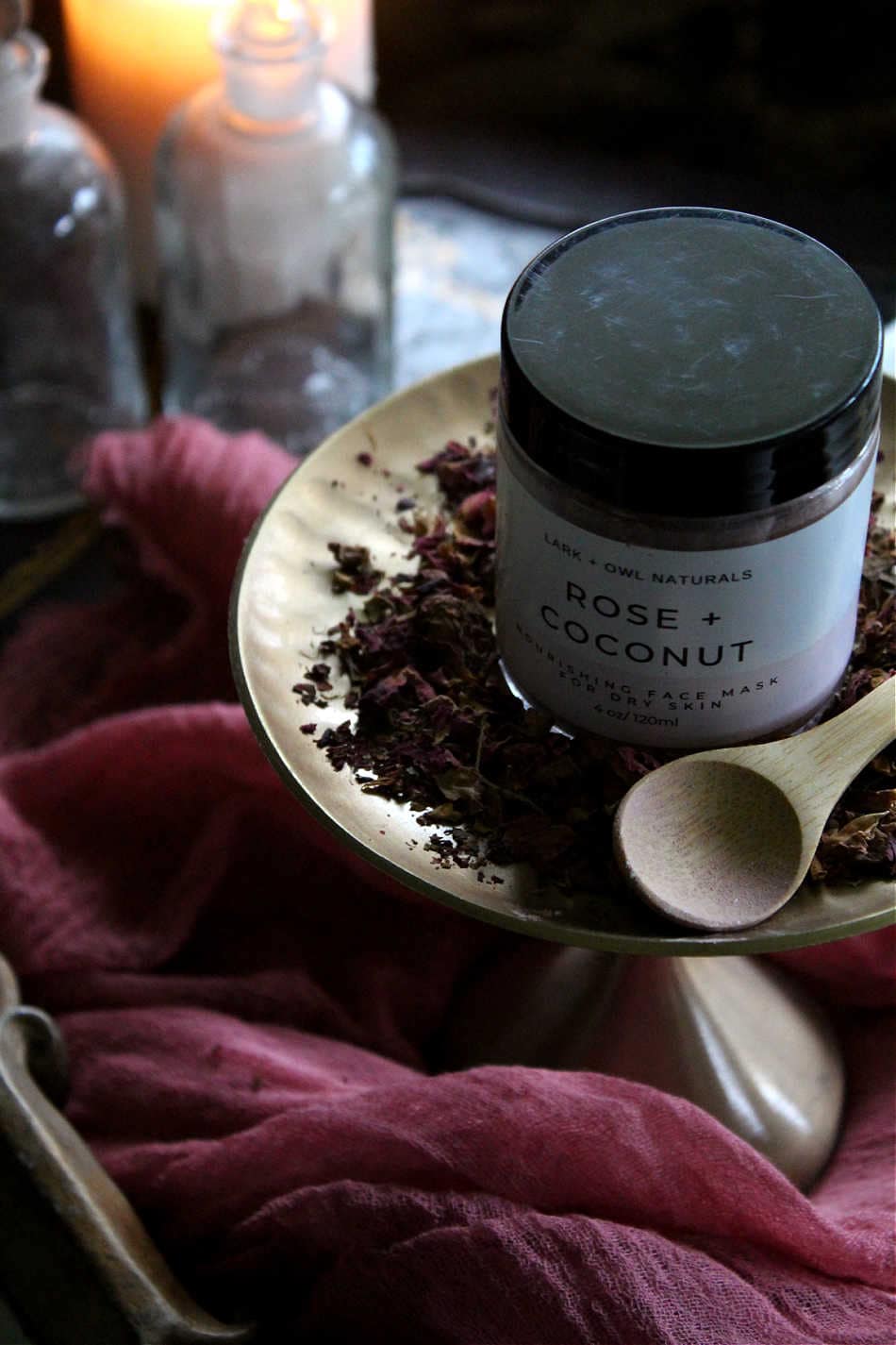 Lark & Owl Naturals Rose + Coconut Face Mask on gold plate with dried rose petals