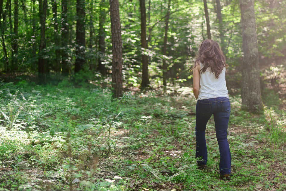 woman walking through the woods