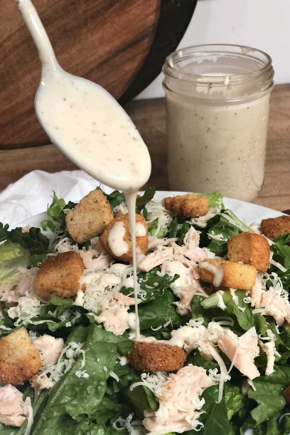 adding homemade (anchovy-free) dressing to chicken Caesar salad