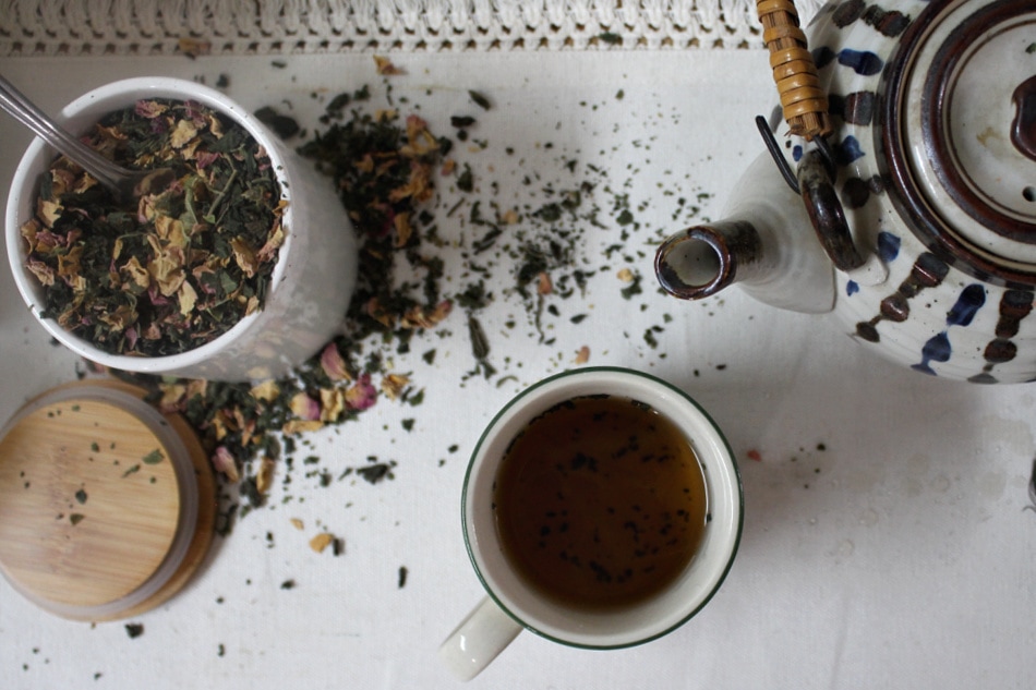 teapot, tea blend, and teacup on table